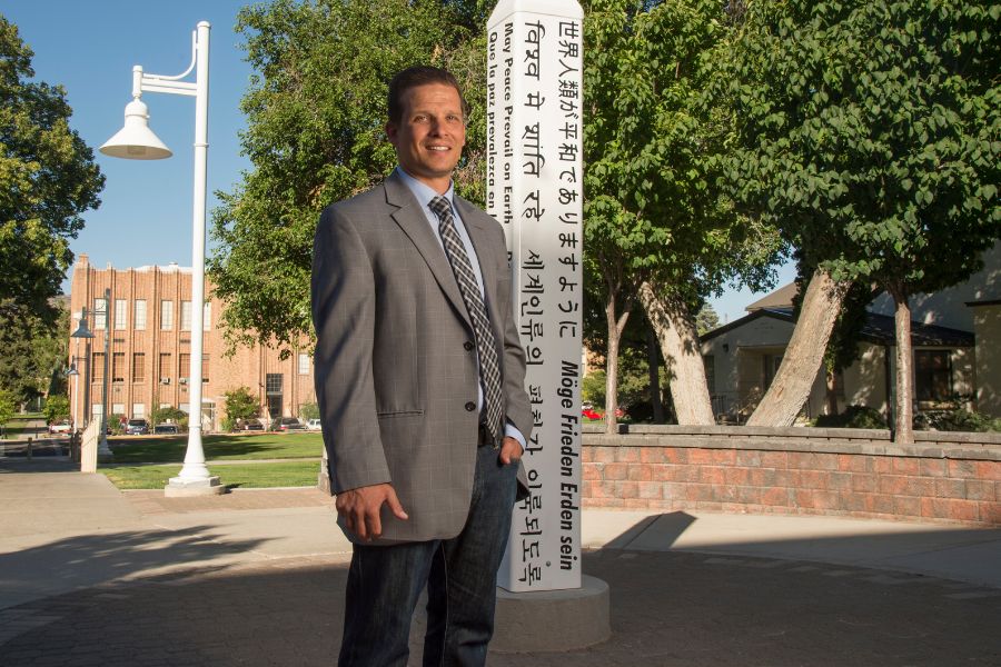 Zackery Heern stands in front of the Peace Pole outside of the Rendevouz building on the ISU Pocatello campus